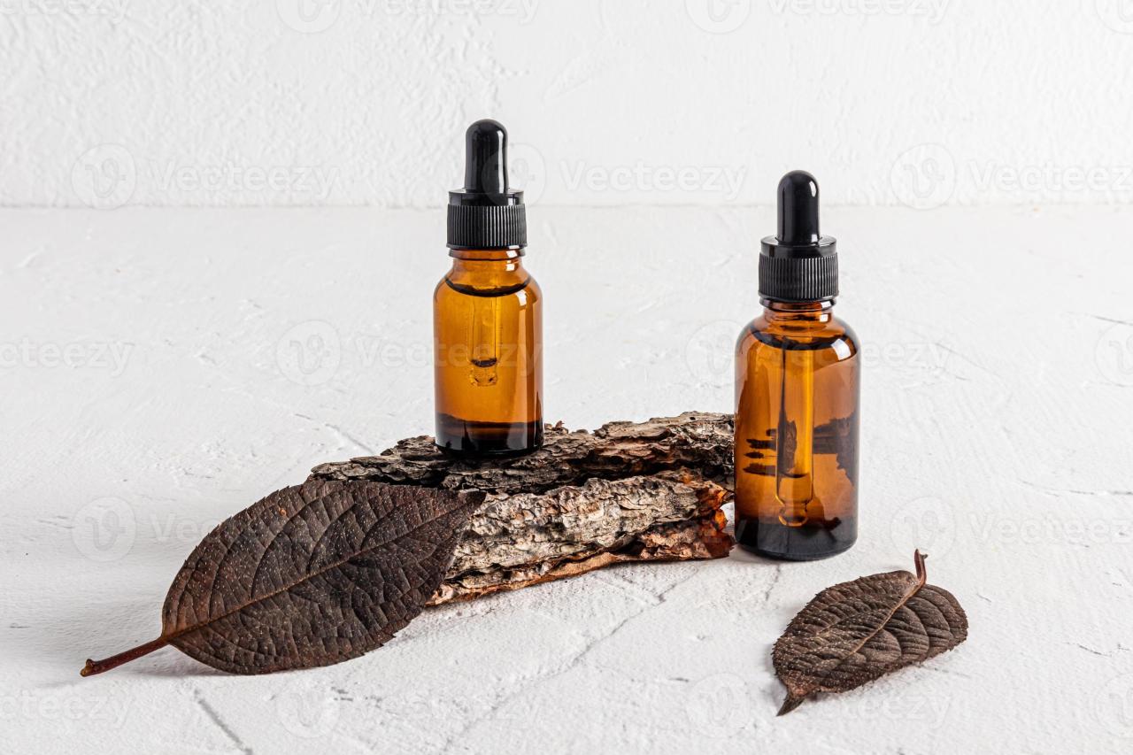 two glass bottles with a dropper with a natural cosmetic for the care of  fading skin of the face stand on the bark of the tree. organic cosmetics.  14390089 Stock Photo at Vecteezy